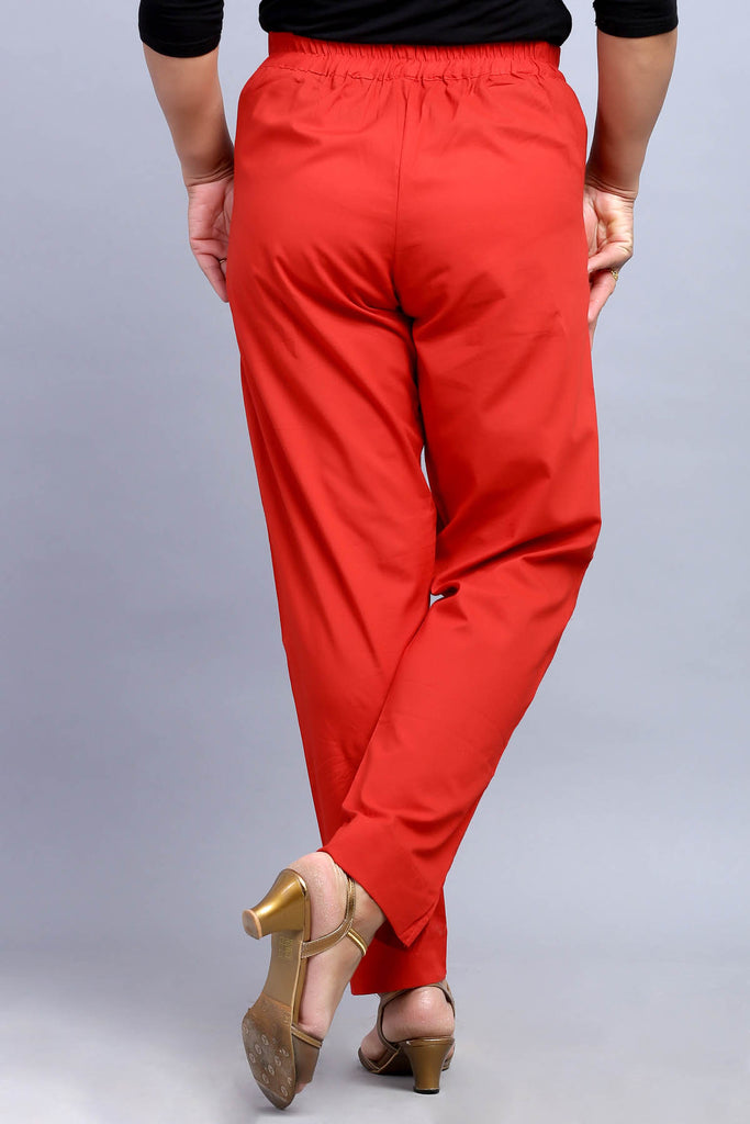 Red solid midrise cigarette trousers has Button and Zip closure With  pockets